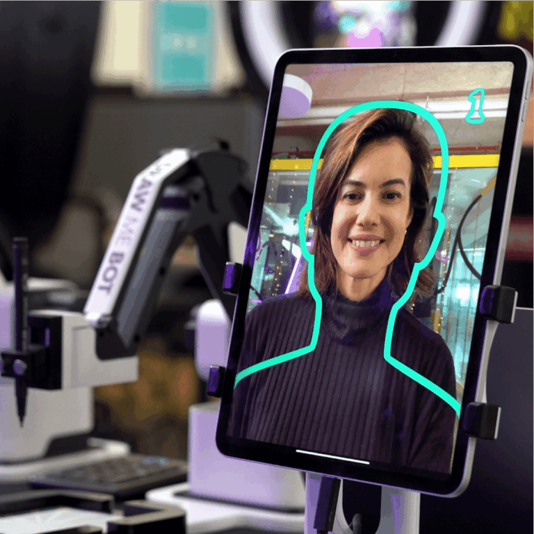 Robo Portraits photo tablet with a drawing robot behind it